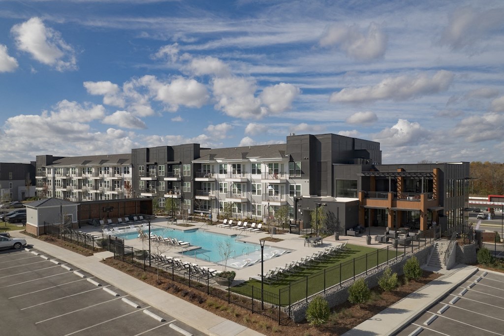 an aerial view of an apartment building with a swimming pool