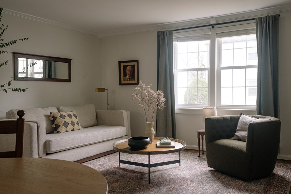 a living room with a couch and a chair and a table