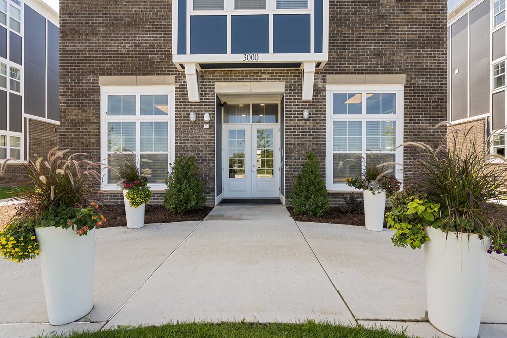 The front of a building with a glass door and windows.