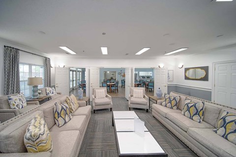 A living room with a grey couch and a white coffee table.
