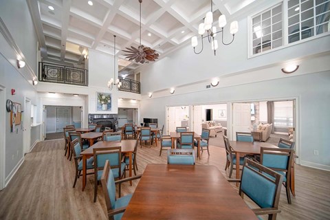 A large dining room with wooden tables and chairs.