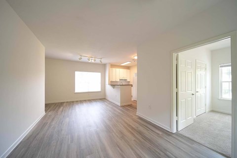 A room with a white door and a window.