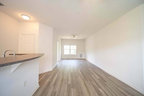 A room with wooden floors and a window.