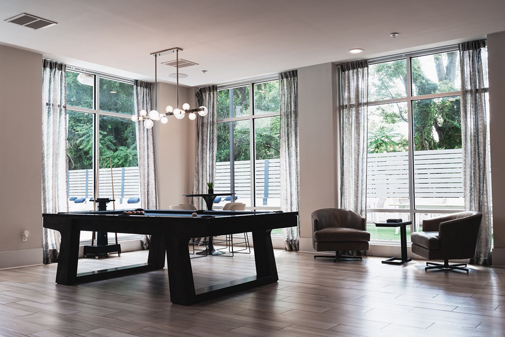 a conference room with a table and chairs and large windows