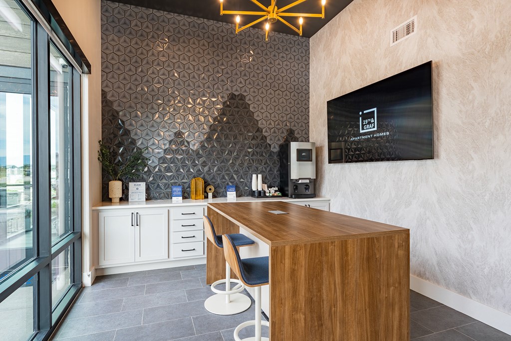 a kitchen with a wooden counter and a tv on the wall