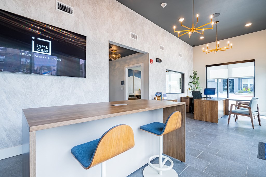 a kitchen with a bar and a dining room with a table and chairs