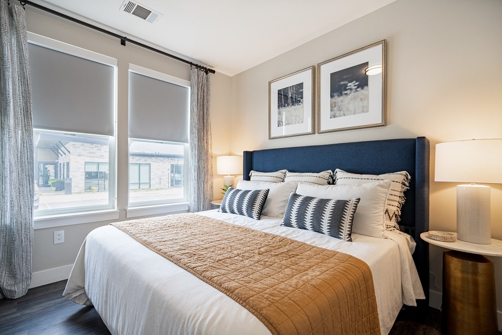 a bedroom with a large bed and a window