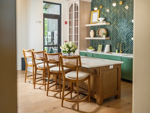 A kitchen with a table and chairs.