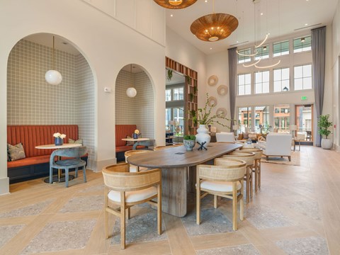 A dining room with a round table and chairs.