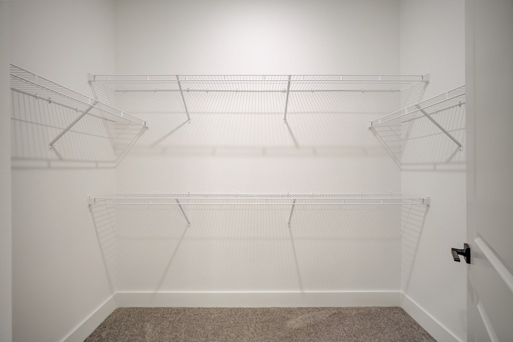 Empty white shelves in a room.