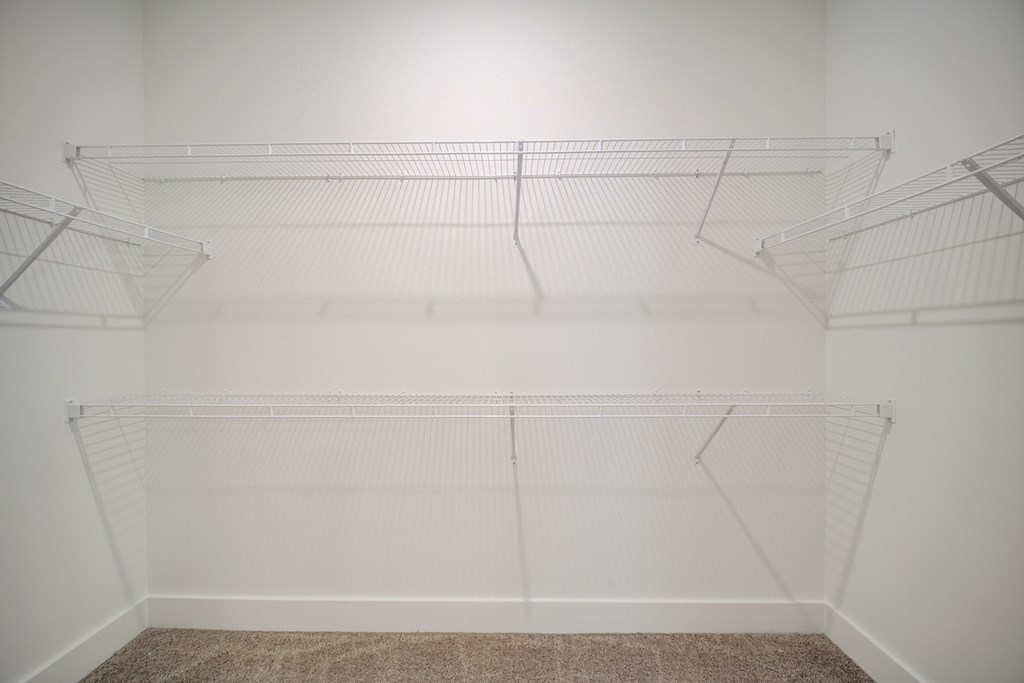 Empty room with white walls and shelves.