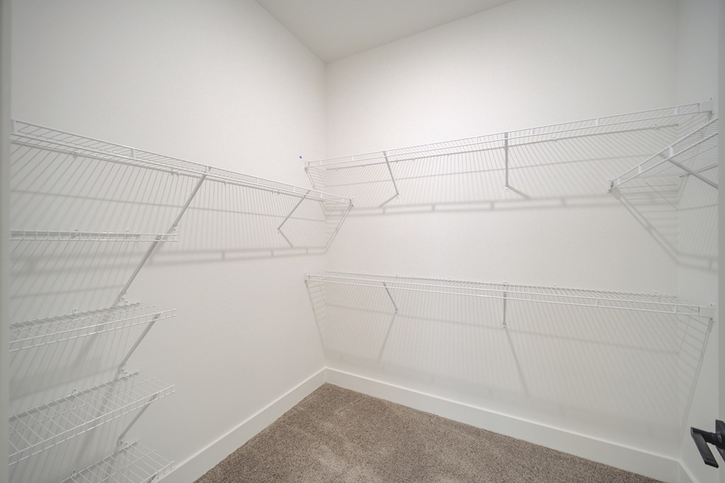 Empty white shelves in a room.