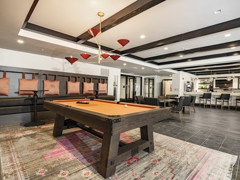 2-Bedroom Luxury Apartments in Savannah Historic District, GA - Capital Collective - Resident Lounge With Billiards Table, Bench Seating, Modern Lighting, Bar Seating, And Open Social Space.