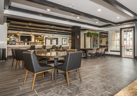 A modern dining room with a long table and chairs.