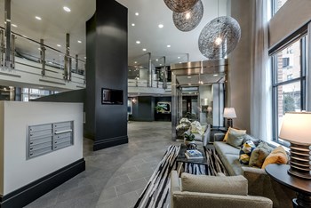 a large living room with a fireplace and large windows - Photo Gallery 13
