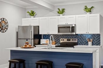 a blue and white kitchen with a counter top
