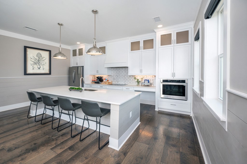 a kitchen with white cabinets and a white counter top