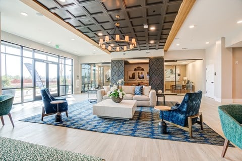 a resident clubhouse with couches chairs and a coffee table