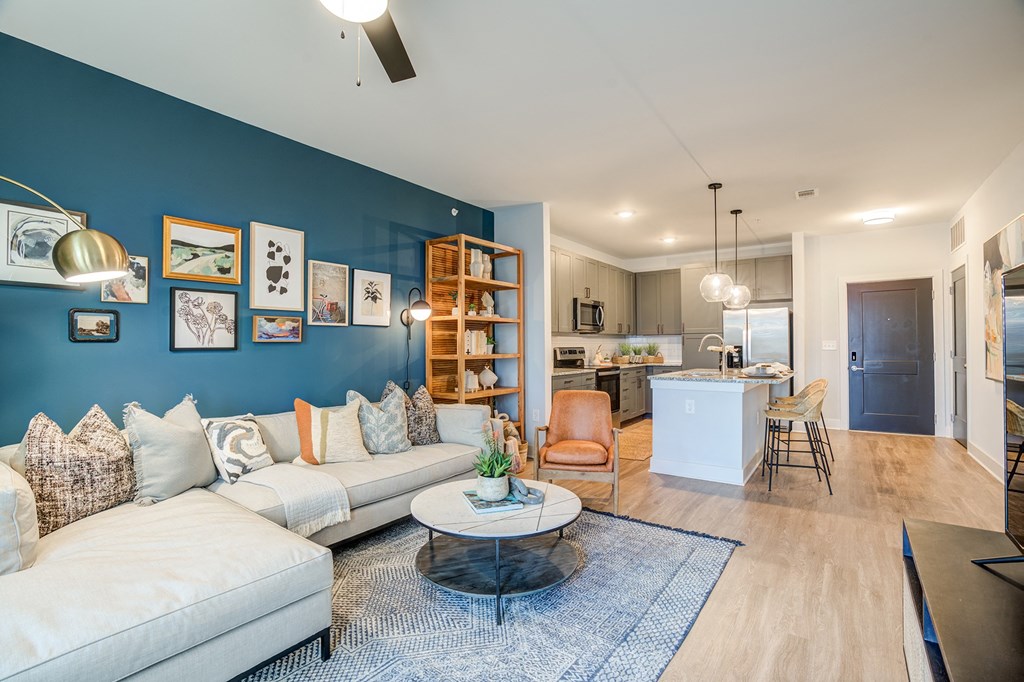 a living room with a blue accent wall and a white couch