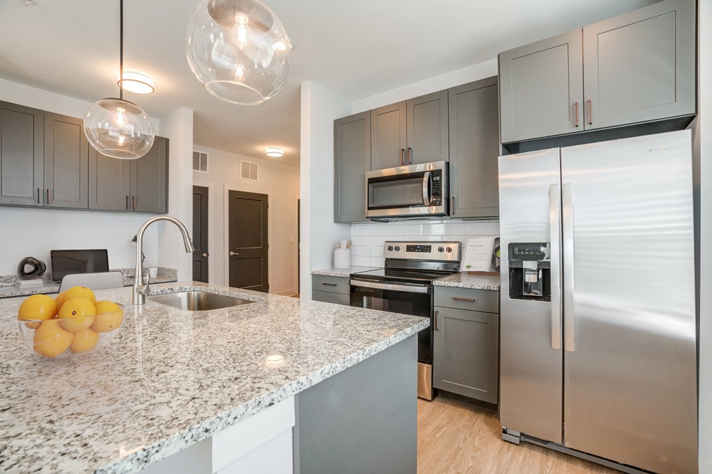 a kitchen with stainless steel appliances and granite counter tops