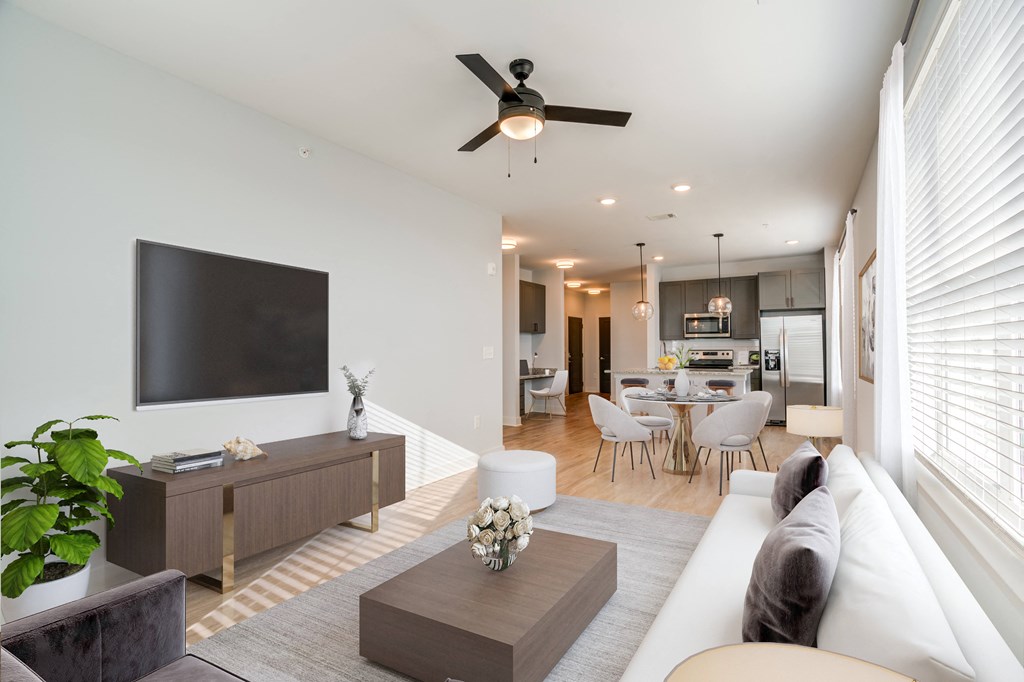 a living room with a white couch and a tv