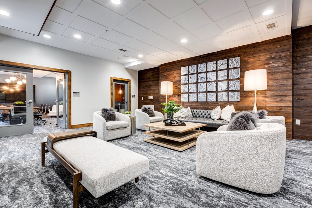 a living room with couches and chairs and a table