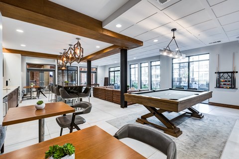 a game room with a pool table and a bar