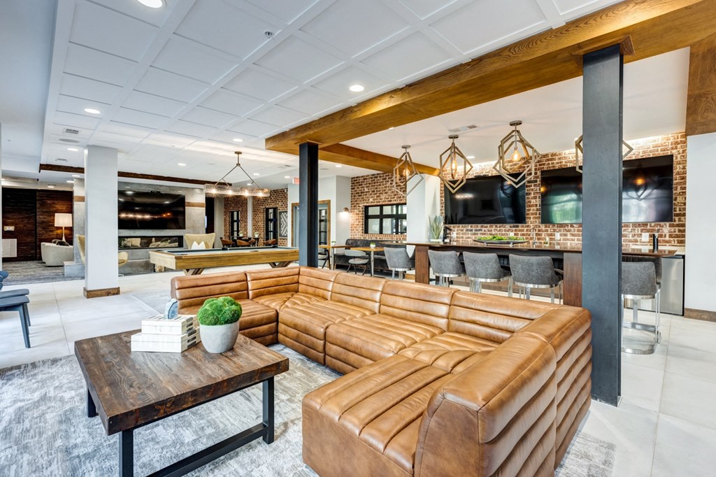 the lobby of a hotel with couches and a bar