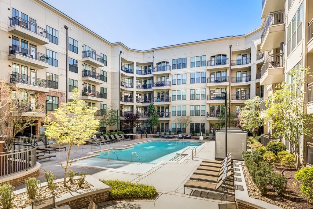 a swimming pool in front of an apartment building