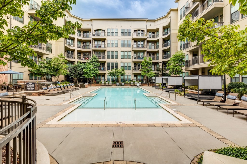 a swimming pool in front of an apartment building