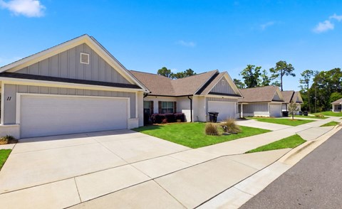 A row of houses with garages and driveways.