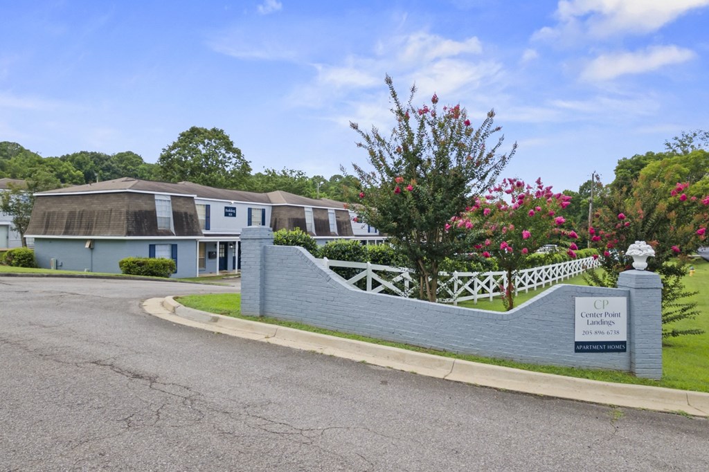 a house with a fence and a street in front of it