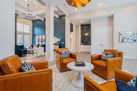 A living room with brown leather chairs and a white coffee table.