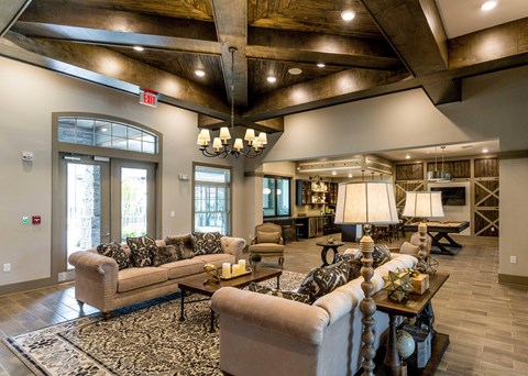 a large living room with couches and chairs and a fireplace