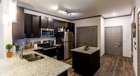 a kitchen with stainless steel appliances and granite counter tops