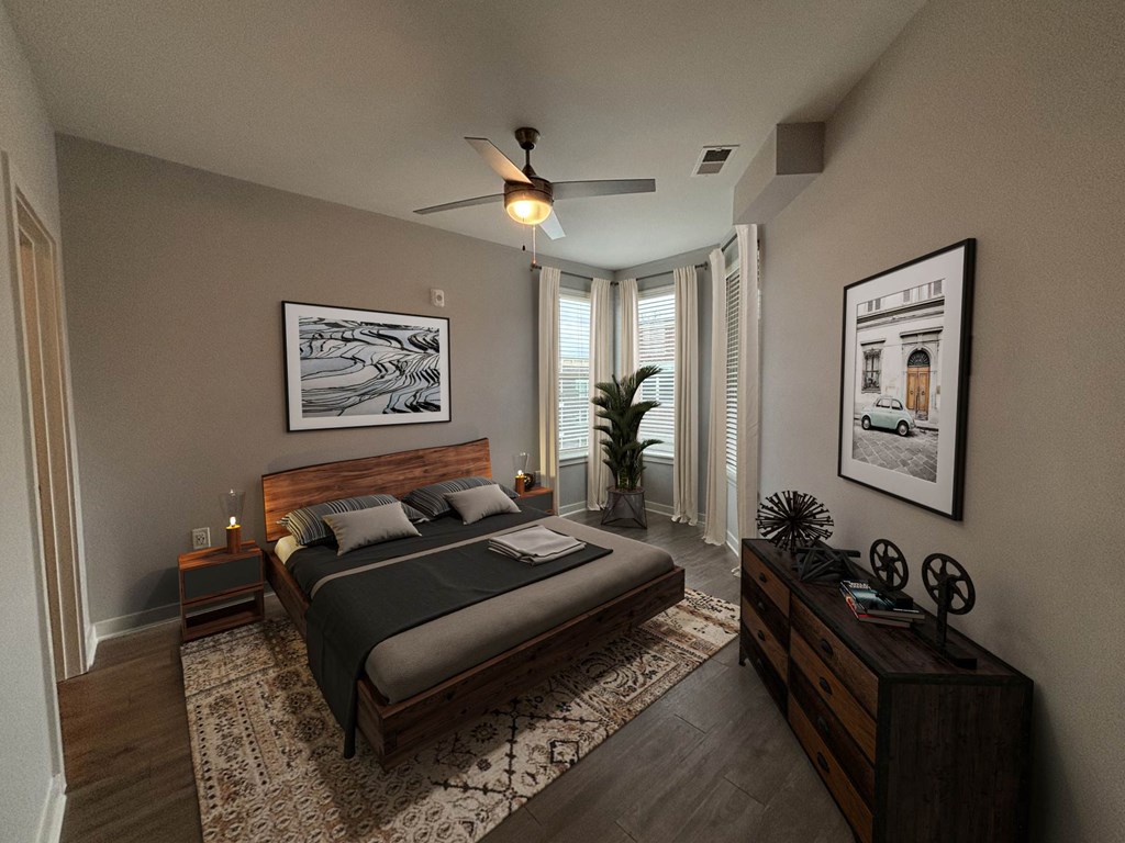 A bedroom with a large bed and a ceiling fan.