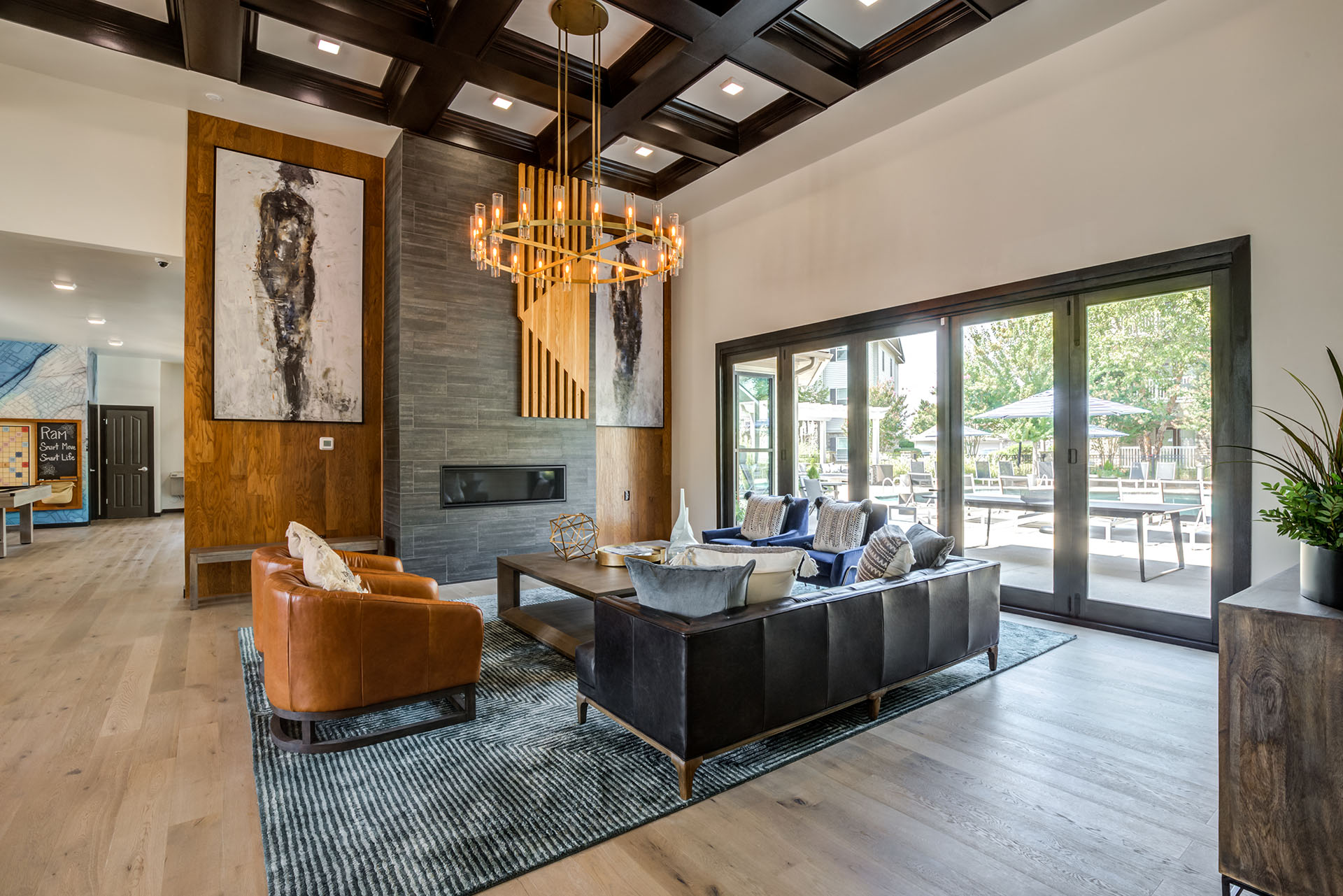 a living room with a leather couch and a chandelier