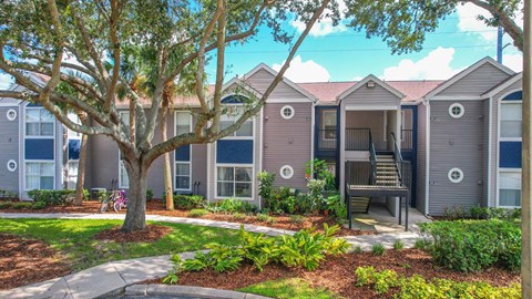 a group of apartments with stairs and trees