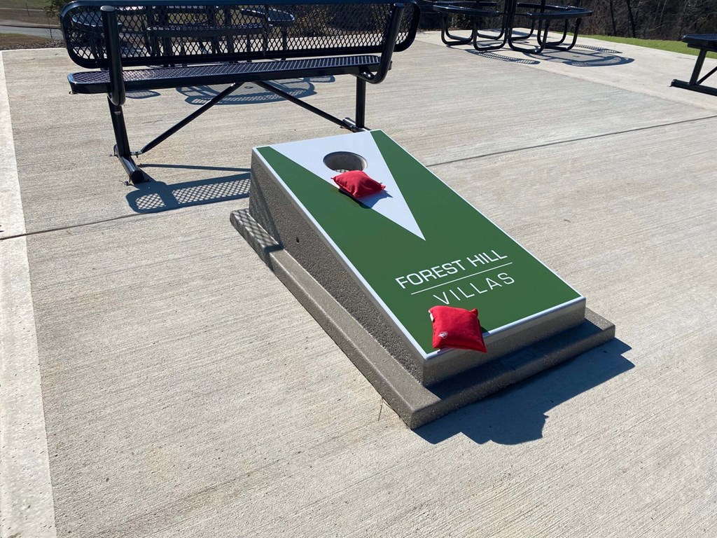 a memorial at the park with a red flower on it