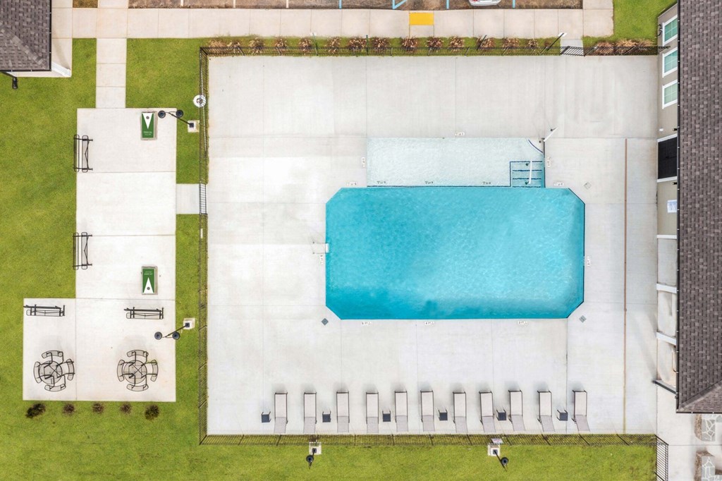 arial view of a swimming pool in a building with grass