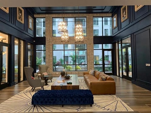 a living room with a large couch and a coffee table in front of a large window at Altis Grand Central, Tampa Florida