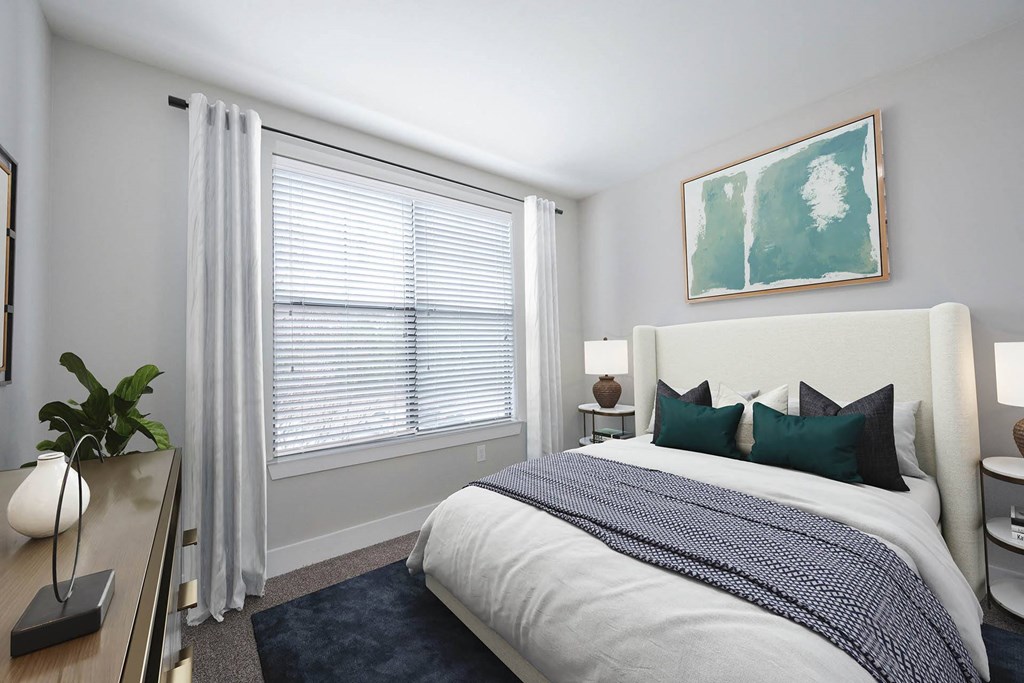 a bedroom with a large window and a large bed