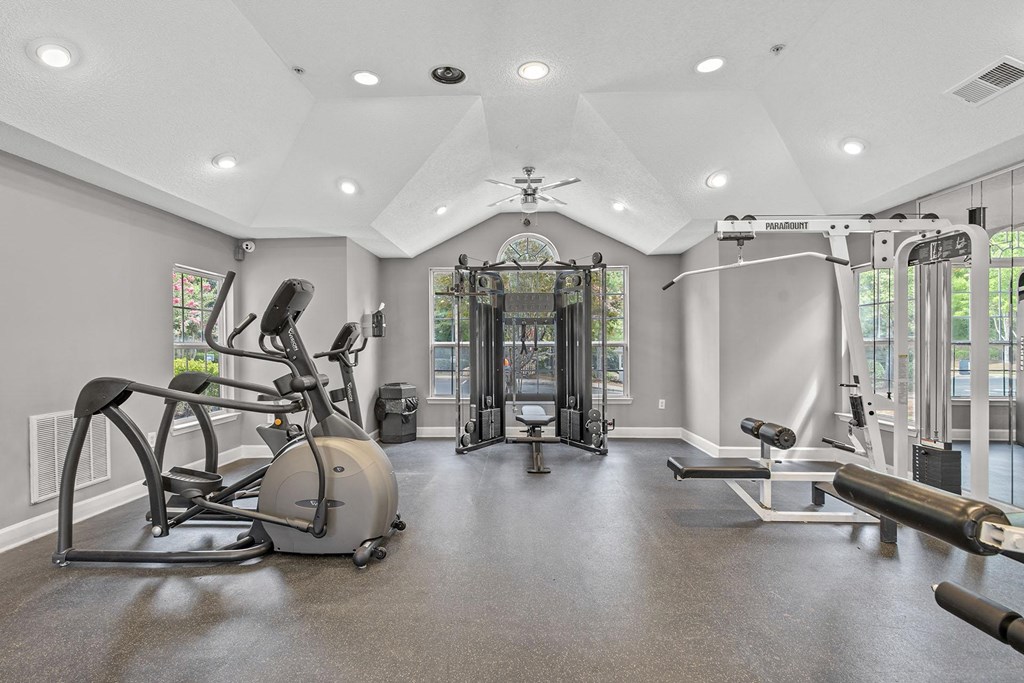 A spacious home gym with a variety of exercise equipment.