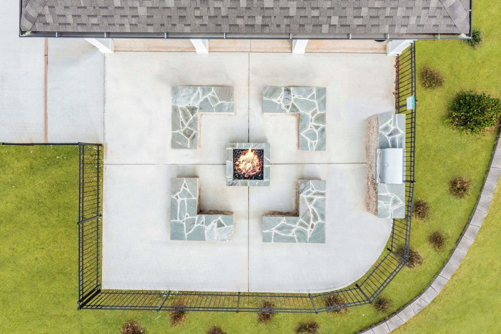 an aerial view of a courtyard with a fireplace in the center