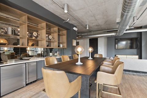 a dining room with a table and chairs and a kitchen