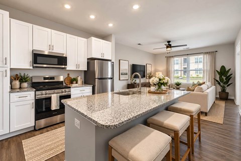 A kitchen with a granite countertop and white cabinets.