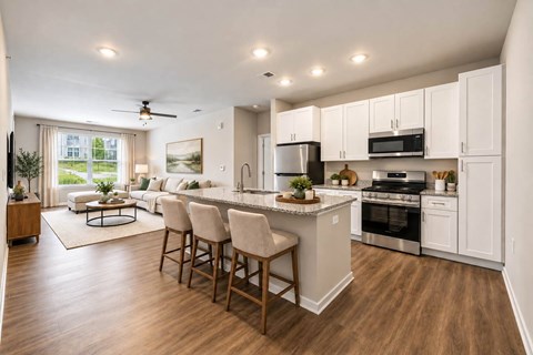 A modern kitchen with a dining area and a ceiling fan.