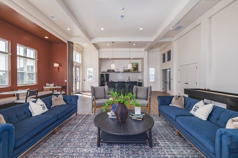 A living room with a dark brown coffee table and blue couches.
