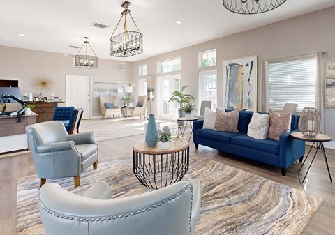 A living room with a blue couch and a grey armchair.