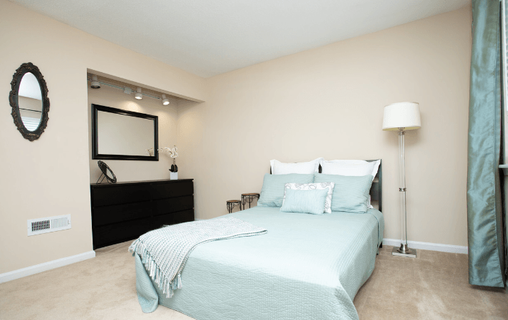 a bedroom with a bed and a dresser